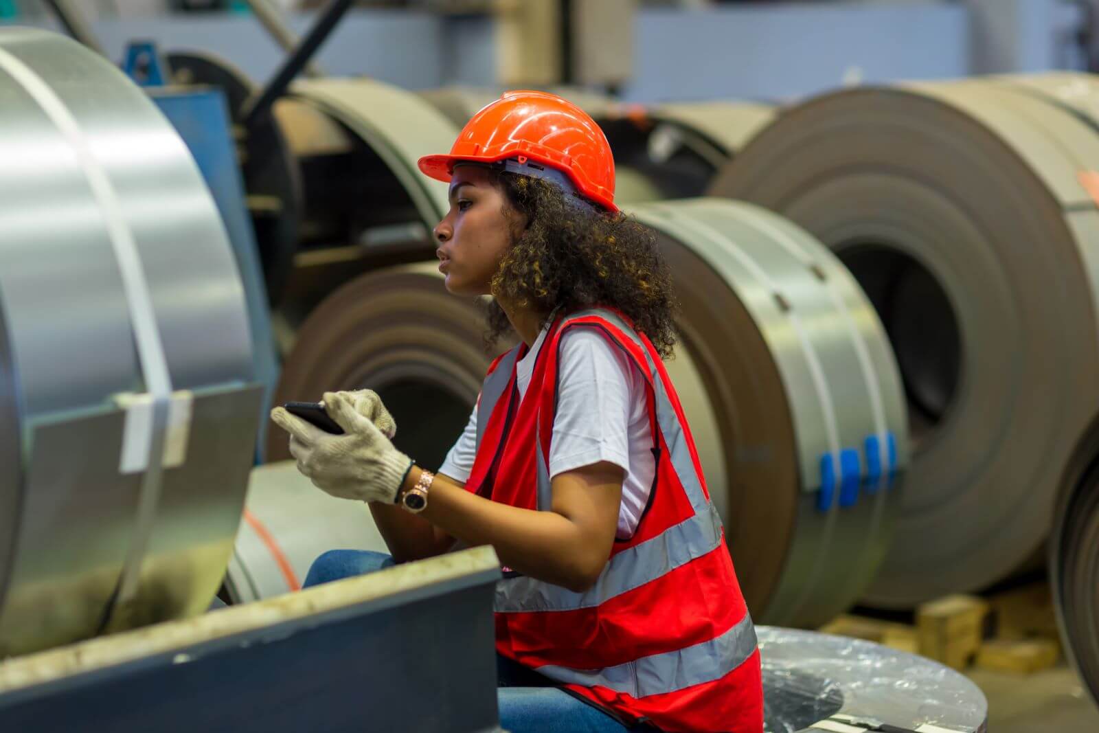 Woman in loud working environment wearing safety gear