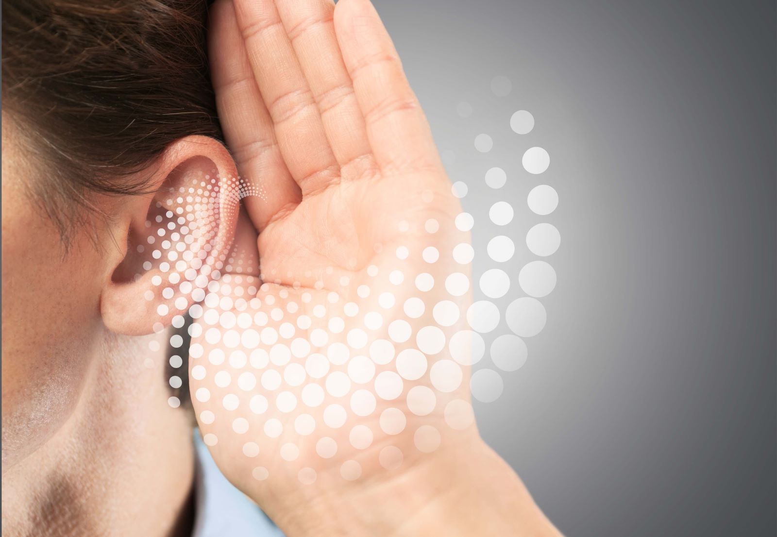 Man with hearing loss cupping ear with sound wave image coming from ear